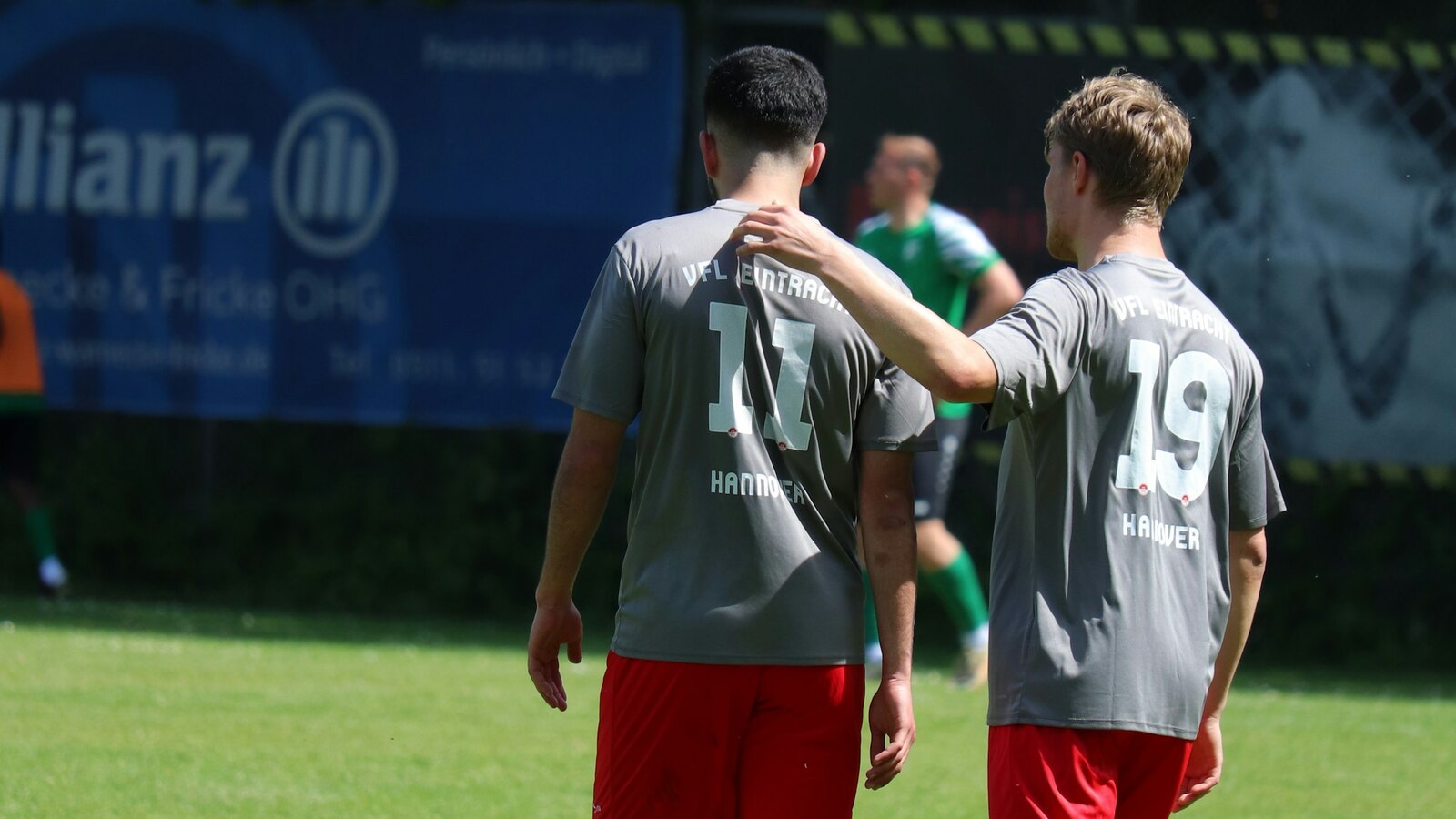 A grassroots football team gathered together on the pitch